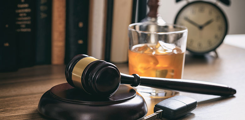 Car-Keys-and-Glass-of-Booze-Next-to-a-Gavel