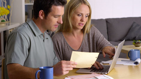 Couple doing paperwork wondering if they'll pass a bankruptcy means test