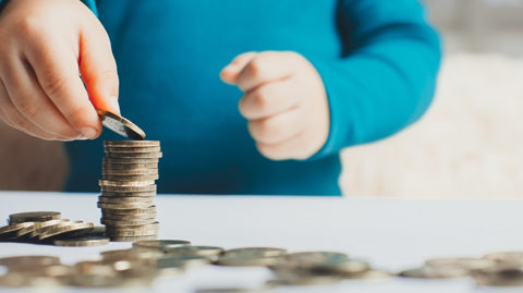 Child stacking money representing child support image