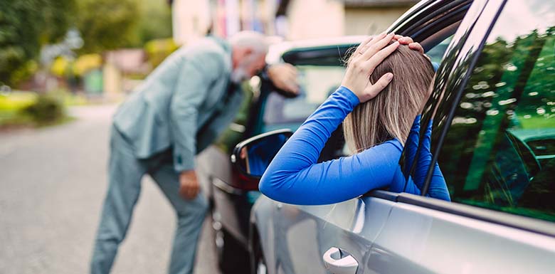 Distressed old man and young woman in car crash